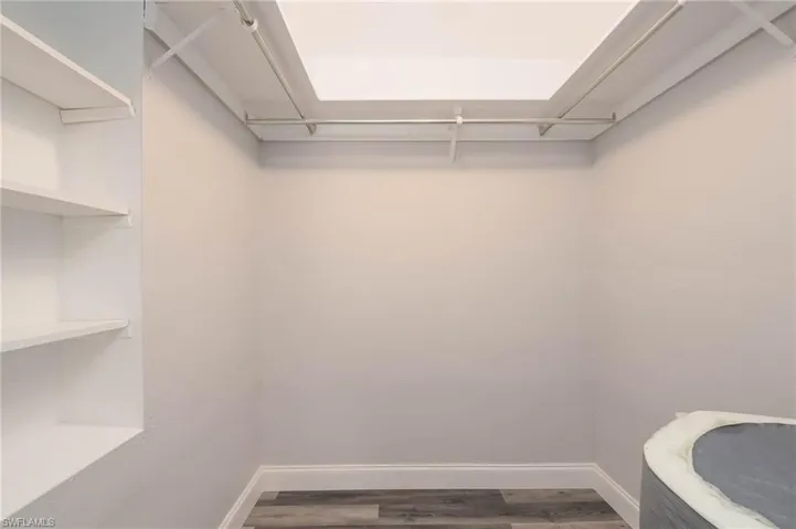 Walk in closet featuring wood finished floors