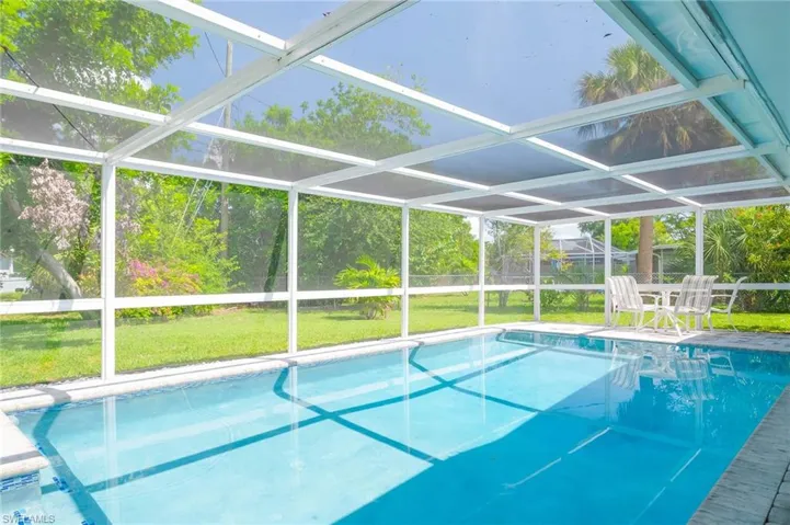 Outdoor pool with glass enclosure