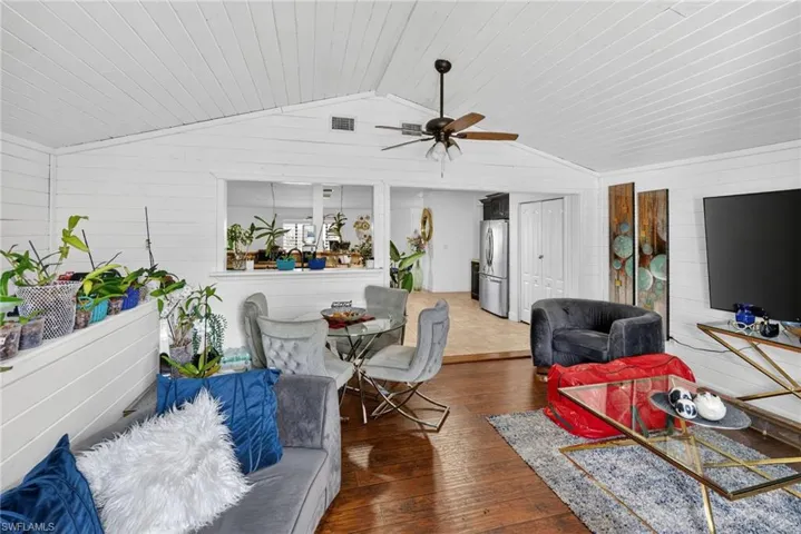 Vaulted white shiplap ceilings with a ceiling fan