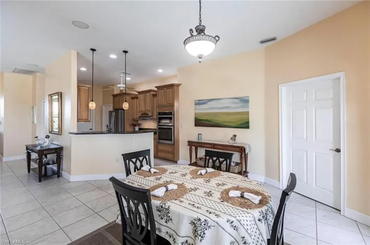 Dining space featuring light tile patterned floors and recessed lighting
