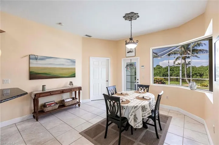 Dining room with light tile patterned floors and baseboards