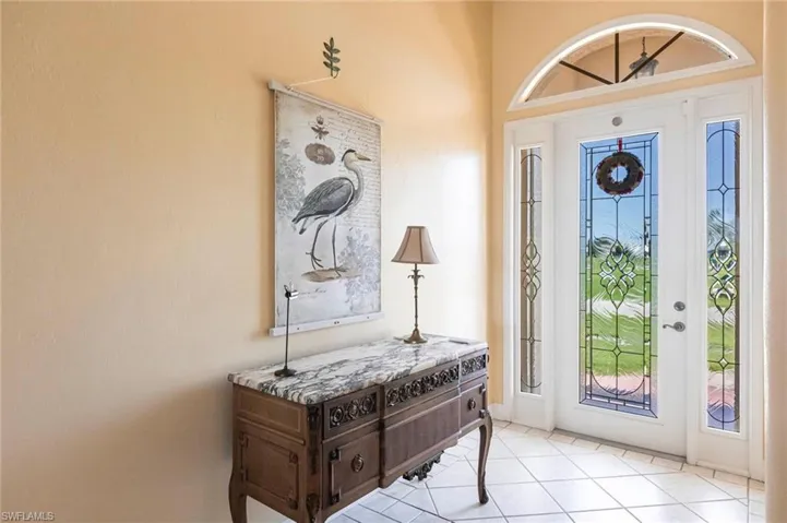 Foyer entrance with light tile patterned flooring