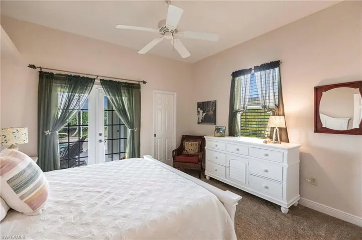 Bedroom featuring access to exterior, carpet, french doors, and ceiling fan