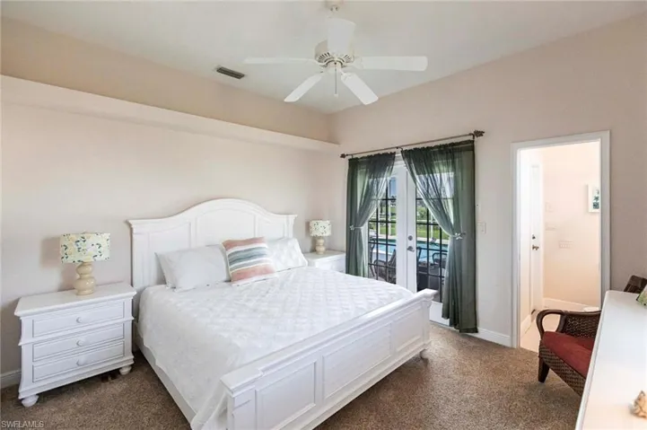 Bedroom featuring access to exterior, carpet floors, french doors, and a ceiling fan