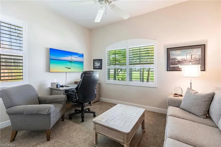 Home office featuring carpet floors and a ceiling fan