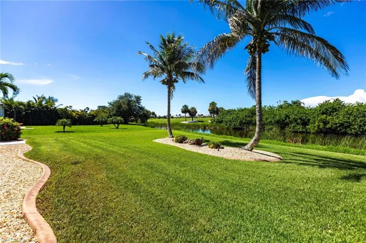 View of green lawn featuring a water view