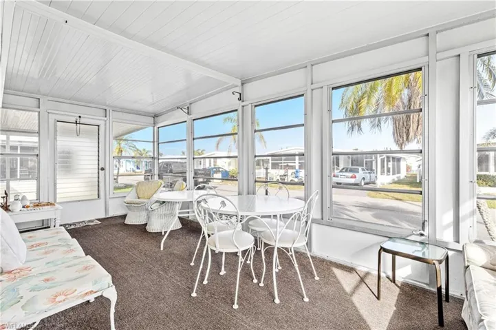 Sunroom / solarium featuring lofted ceiling