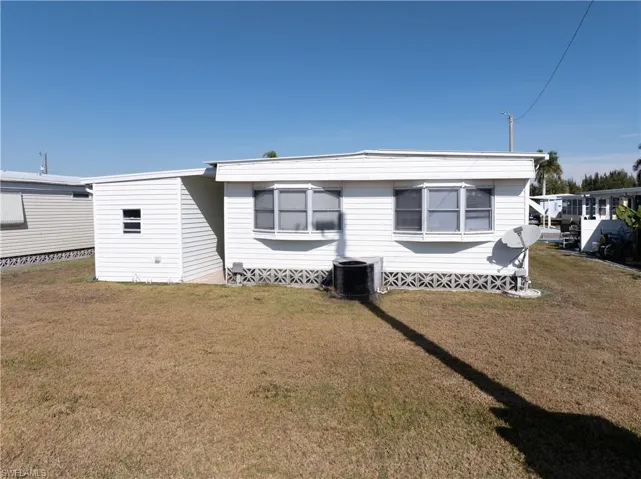 Rear view of house with a yard