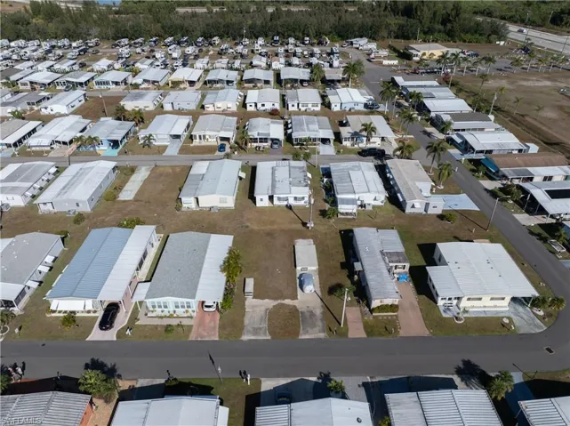Aerial view of property and surrounding area featuring nearby suburban area