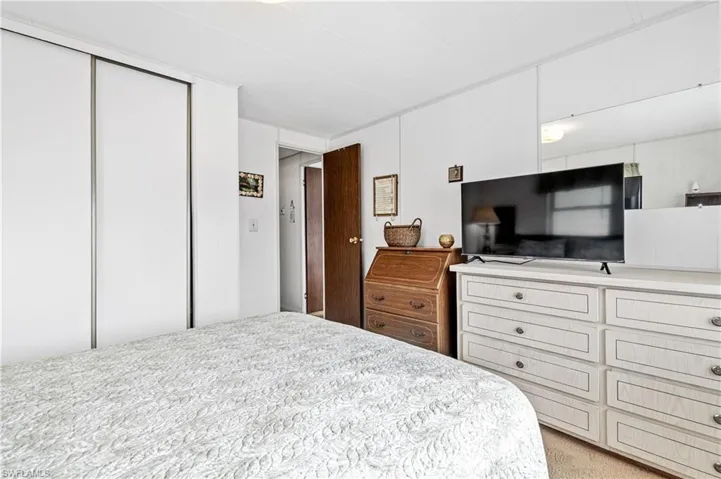 Bedroom featuring a closet and light carpet