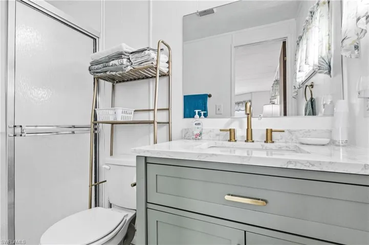 Bathroom with vanity and a shower stall