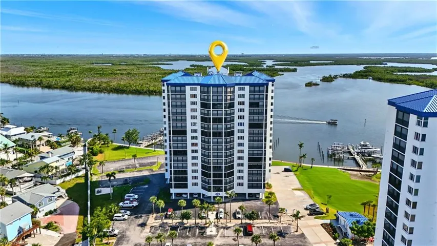 Drone / aerial view of a condominium building and a large body of water - Virtually Edited Image