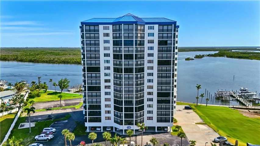 View of condminium building featuring a water view - Virtually Edited Image