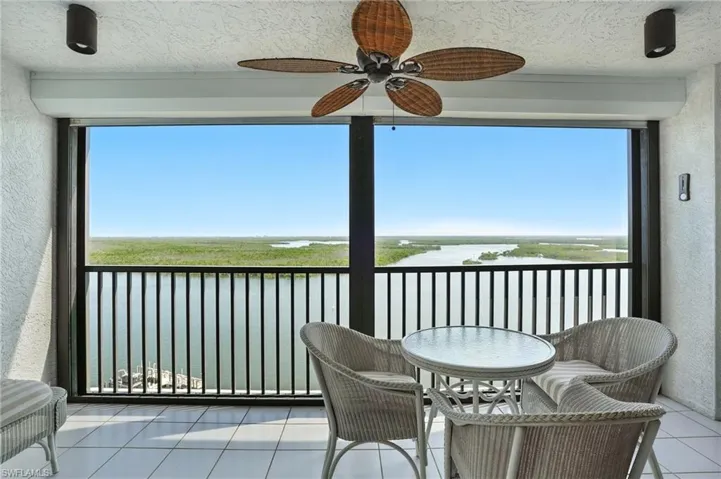 Balcony with a water view and a ceiling fan - Virtually Edited Image