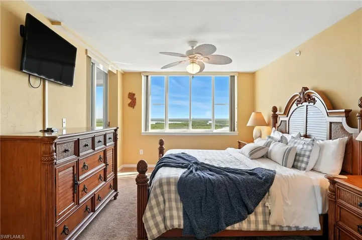 Bedroom with beige carpet and a ceiling fan - Virtually Edited Image