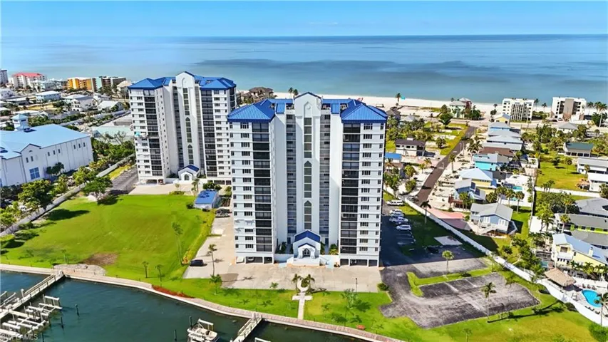 Aerial view of a large body of water and condominium buildings - Virtually Edited Image