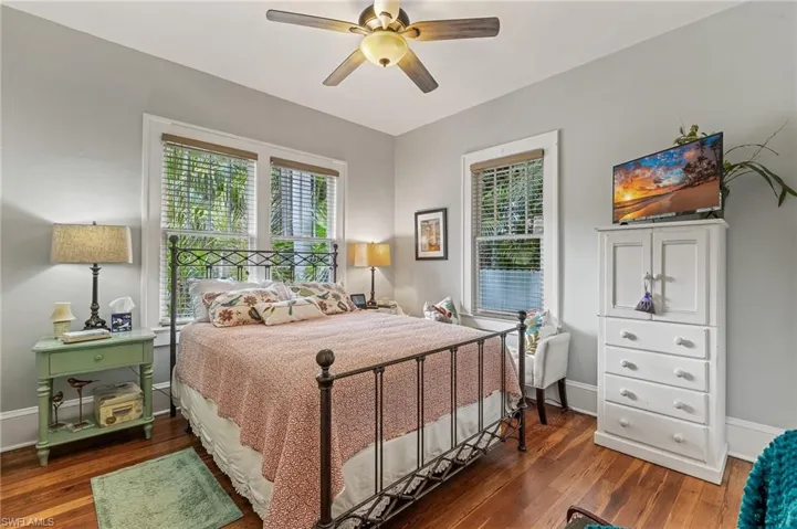 Bedroom with dark wood-style flooring and ceiling fan