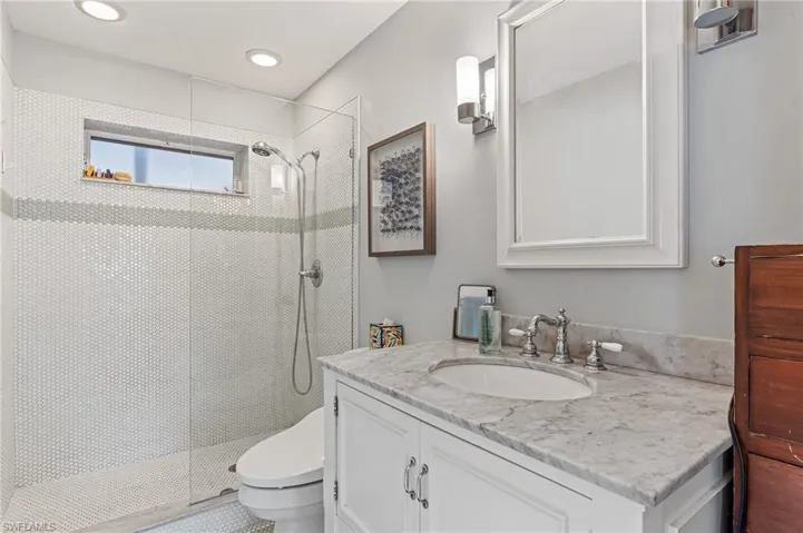 Bathroom featuring vanity and a walk in shower