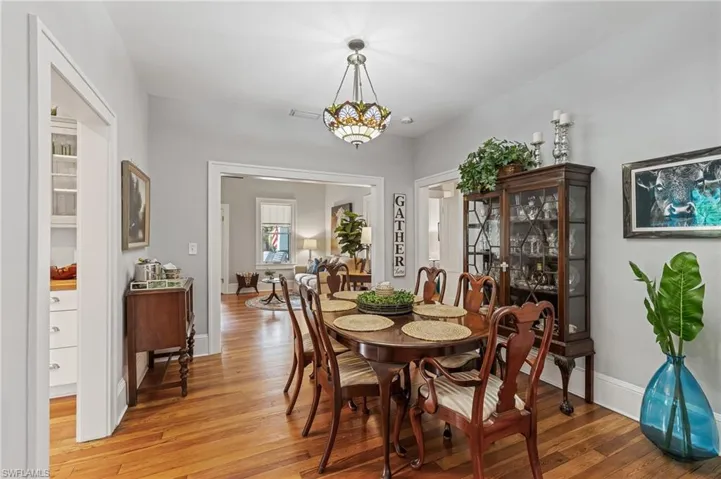 Dining room with light wood-type flooring and a chandelier
