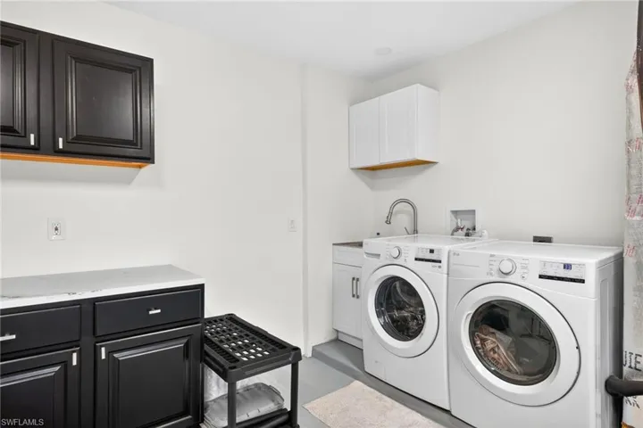 New washer/dryer, and AC unit in the garage/office area