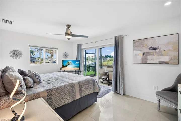 Primary Bedroom with view of canal and access to newly screened-in lanai area