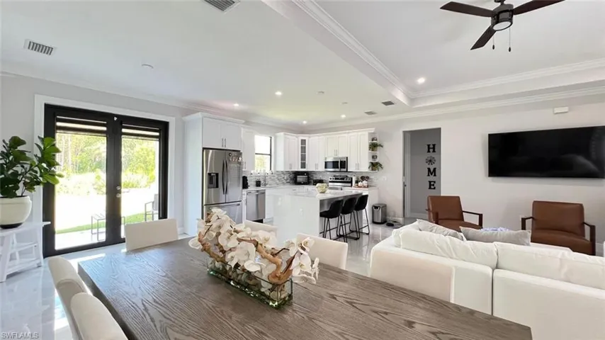 Dining room featuring french doors, a ceiling fan, recessed lighting, and ornamental molding
