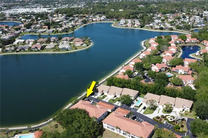 Drone / aerial view with a residential view and a water view