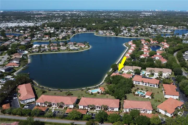 Birds eye view of property with a water view