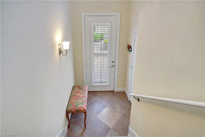 Entryway featuring dark tile floors