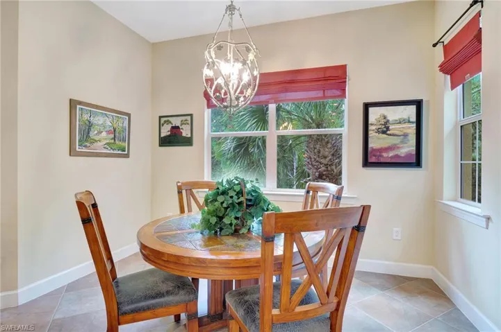 Tiled dining area with a chandelier