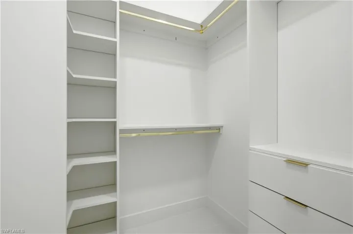 Walk in closet with tile patterned flooring