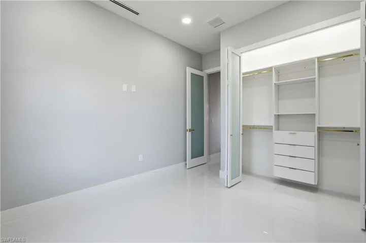 Unfurnished bedroom with light tile patterned flooring, a closet, and recessed lighting