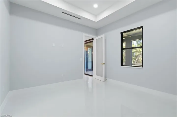 Tiled spare room with recessed lighting
