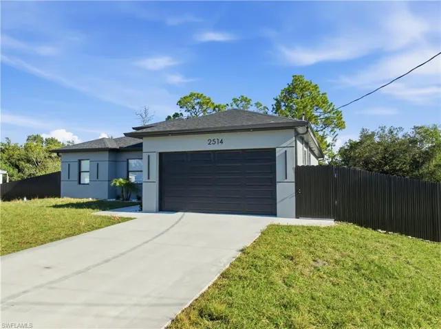 View of front of house with stucco siding, concrete driveway, an attached garage, and roof with shingles