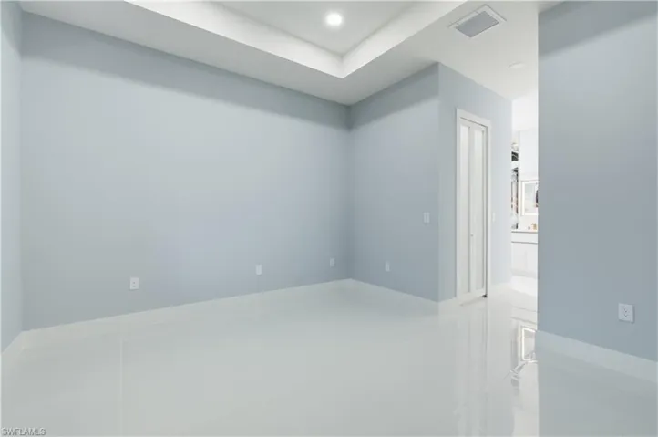 Tiled empty room featuring recessed lighting and baseboards