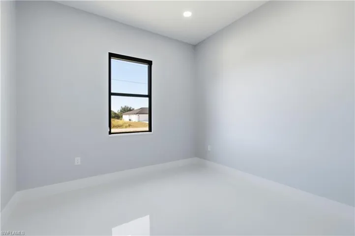 Spare room featuring recessed lighting and baseboards