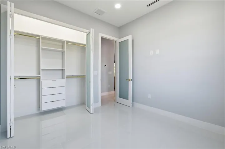 Unfurnished bedroom with light tile patterned floors, a closet, and recessed lighting