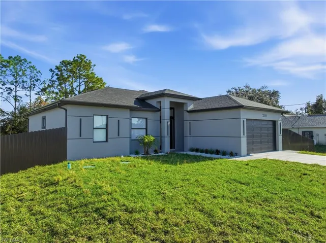 View of front of property with stucco siding, a garage, concrete driveway, and roof with shingles