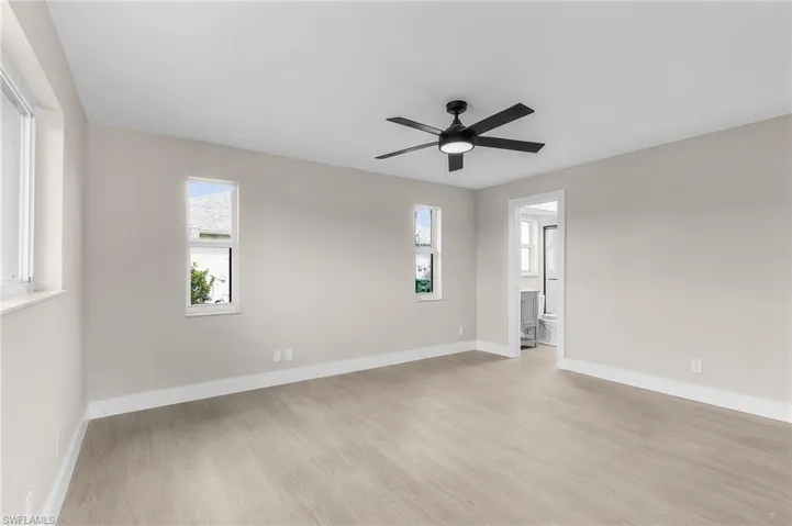 Empty room featuring light wood-style flooring and ceiling fan