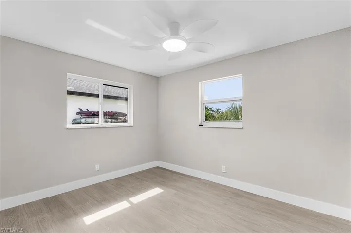 Empty room featuring light wood-style flooring and a ceiling fan