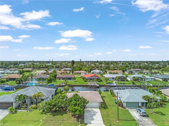 Aerial perspective of suburban area featuring a nearby body of water