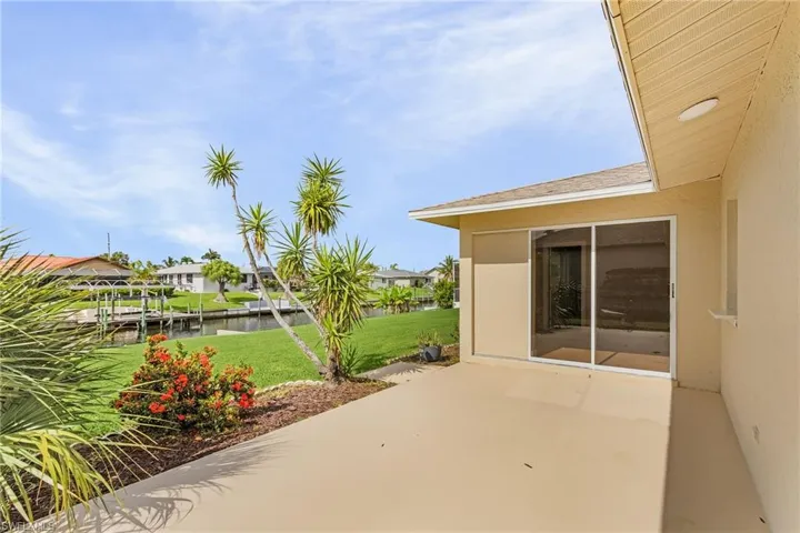 View of patio with a residential view, a water view, and a boat dock