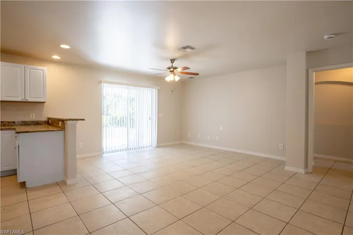 Unfurnished living room featuring light tile patterned flooring, recessed lighting, and a ceiling fan