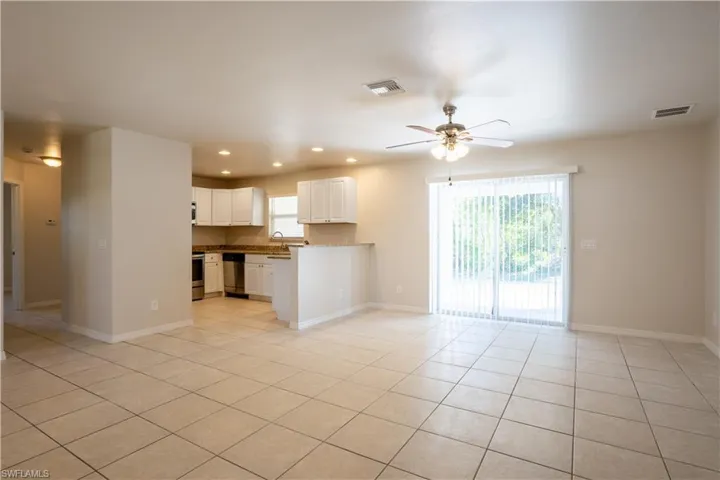 Unfurnished living room with light tile patterned floors, recessed lighting, and ceiling fan