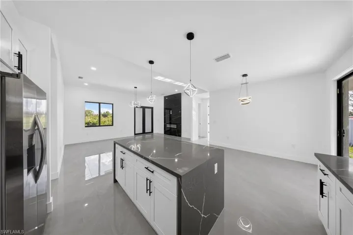 Open-concept interior featuring light gray tile flooring and white walls