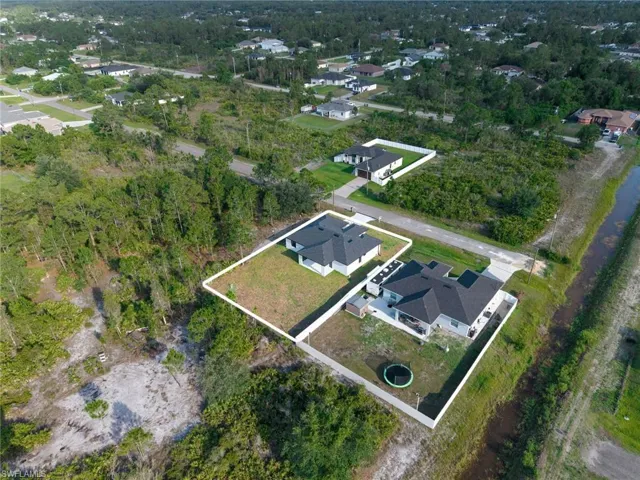 Aerial perspective of a property with a distinct perimeter fence