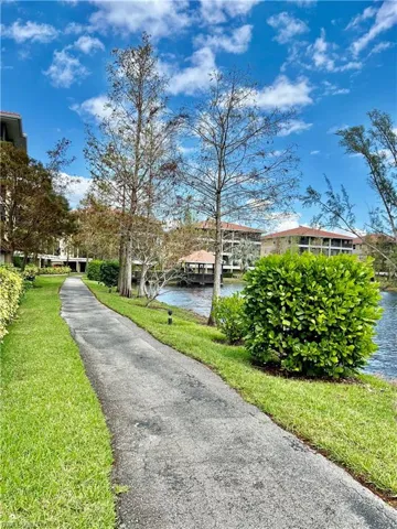 View of community with a yard and a water view