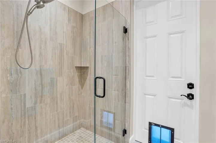 Bathroom with a shower with shower door, vanity, hardwood / wood-style flooring, and toilet