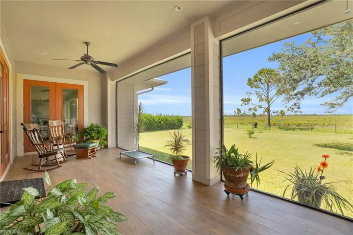 Back of property featuring a garage and a lawn