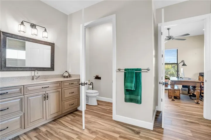 Office with plenty of natural light, light hardwood / wood-style flooring, and ceiling fan